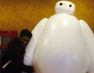 A Betmax inflatable from the movie 'Big Hero 6' having one of its hands hugged by me.
