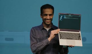 A screenshot of the CEO holding a Framework 13' with a translucent purple bezel